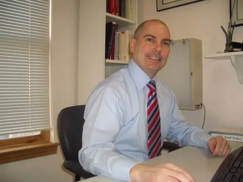 Dr. Stephen R. Leone seated at his desk