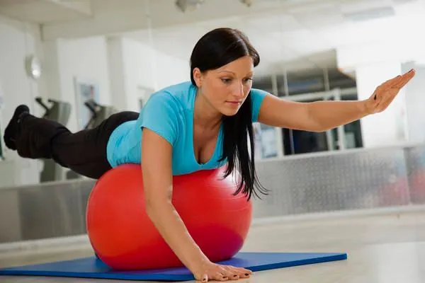 Woman doing a corrective exercise on a stability ball