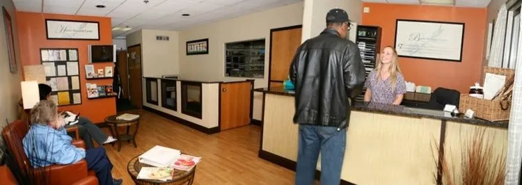 Front desk and reception area with patients waiting