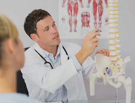Doctor explaining the spine with an anatomical model